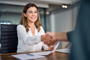 Happy,Mid,Aged,Business,Woman,Manager,Handshake,At,Office,Meeting.